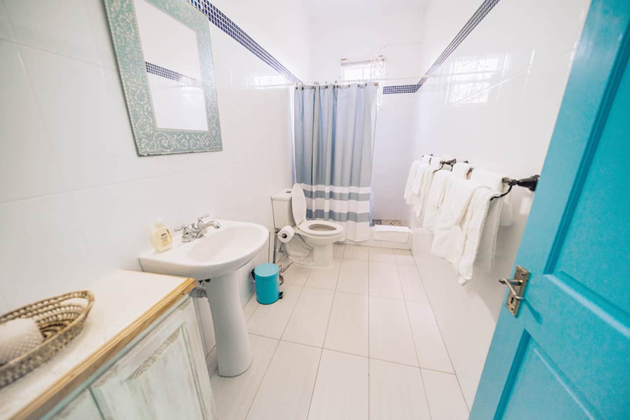 Private bathroom stocked with towels and toiletries.