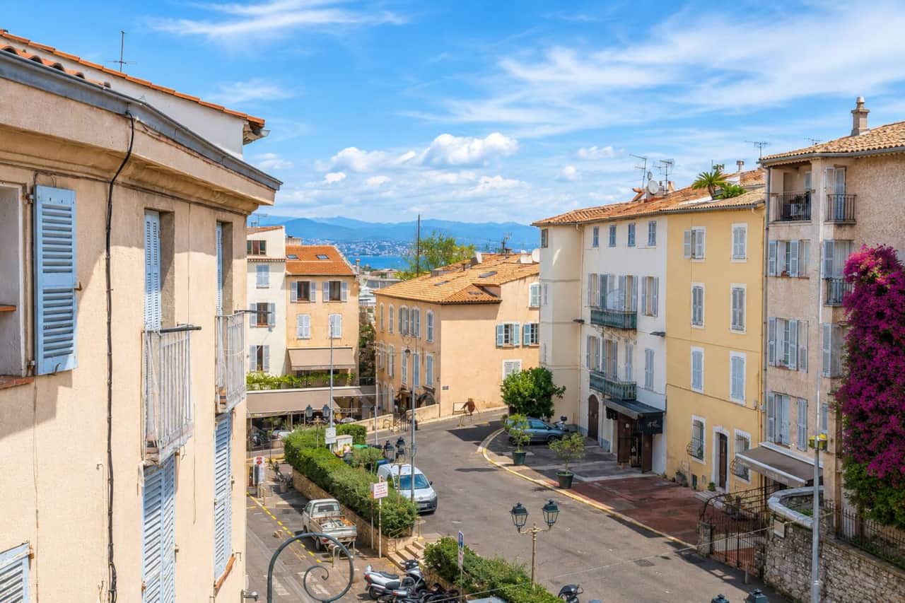 View of the port and mountains from the bedroom, steps from the historic city gate to Port Vauban