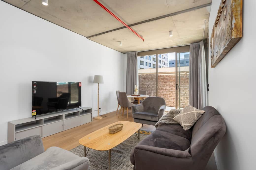 Immerse yourself in the tranquility of our tastefully decorated living area. The plush sofa and state-of-the-art entertainment system are your companions for a relaxing evening in the heart of the city.