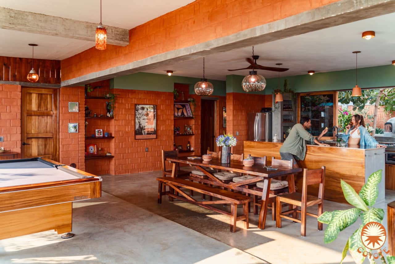Open-plan living room with pool table, kitchen, and private pool