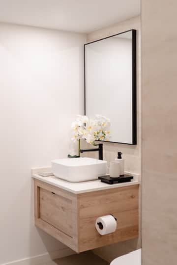 Calming ensuite retreat with warm lighting and stylish details.