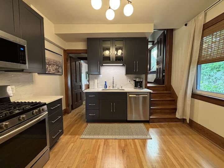 Modern, fully equipped kitchen with stainless steel appliances, sleek cabinetry.
