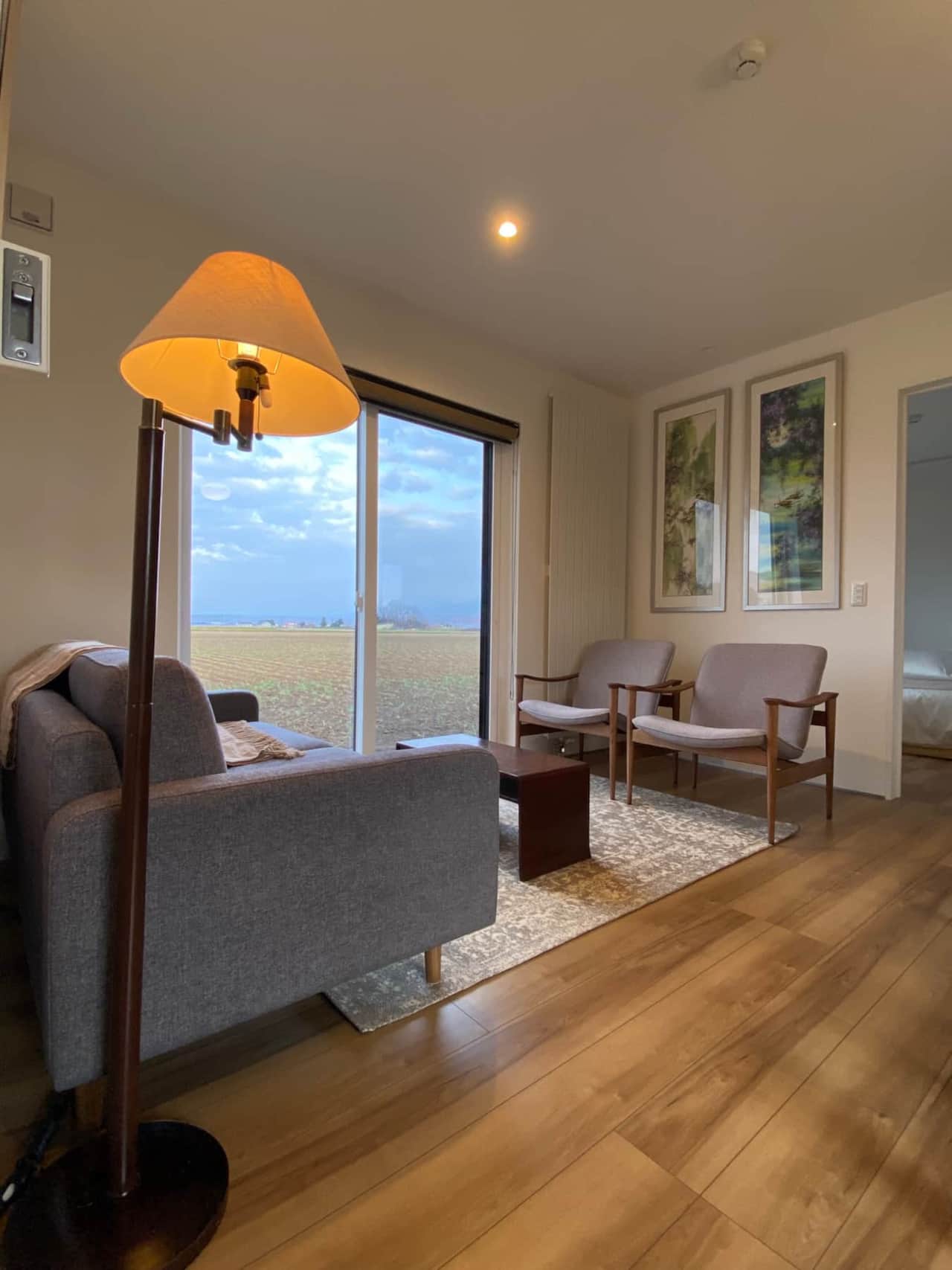 茜Akane 2-bedroom suite lounge area to enjoy views of Furano's farm fields and surrounding mountains