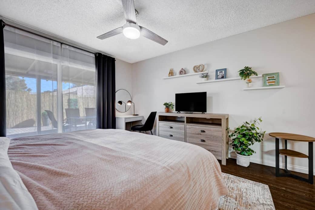 Mater Bedroom and bathroom with blackout curtains, King Size Bed with 14 inch thick mattress and 100% Cotton Beddings, LG Smart Tv, work station/make-up area connected to the backyard.