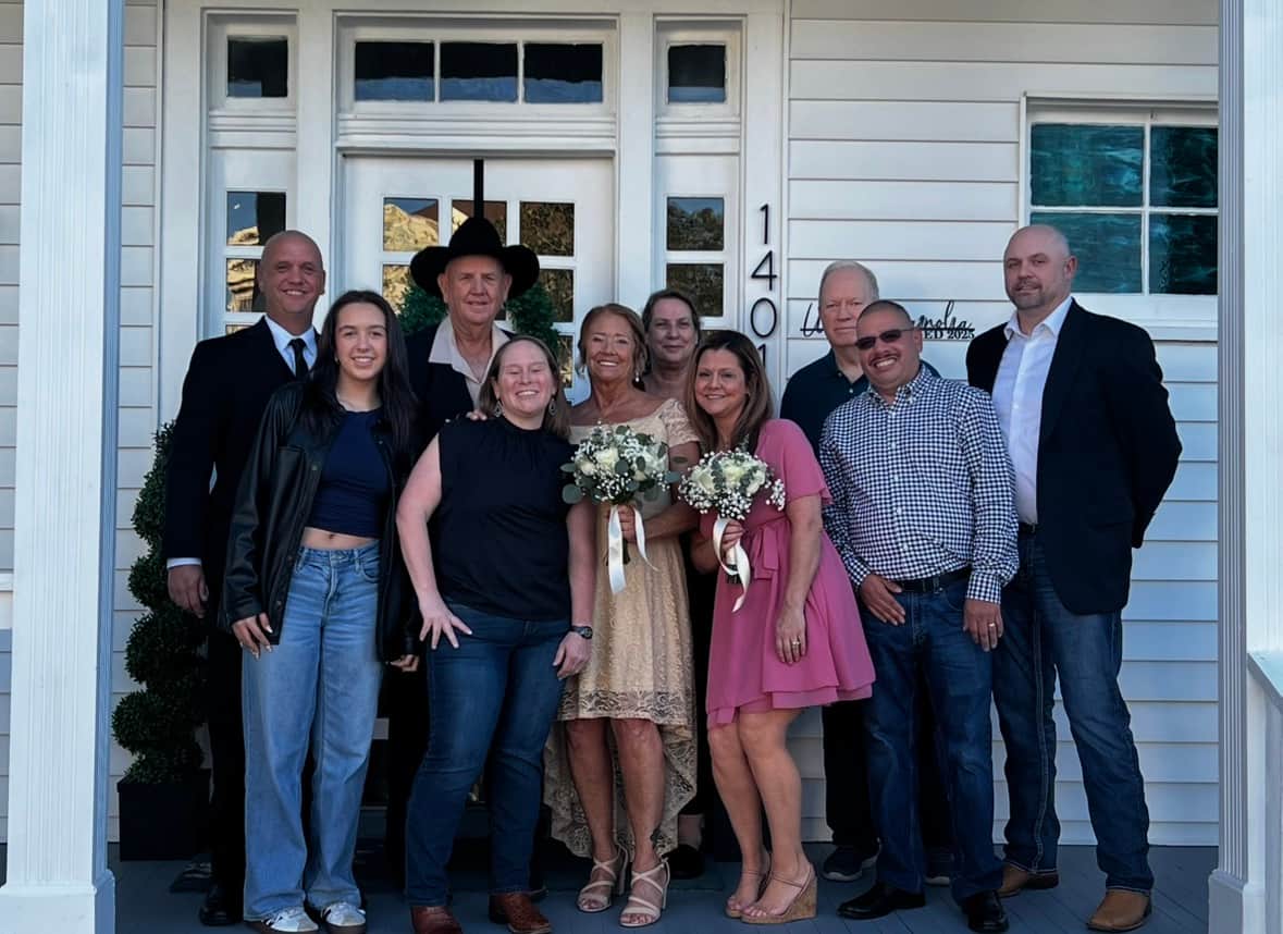Family celebrating a wedding on the front porch of White Magnolia Galveston historic home