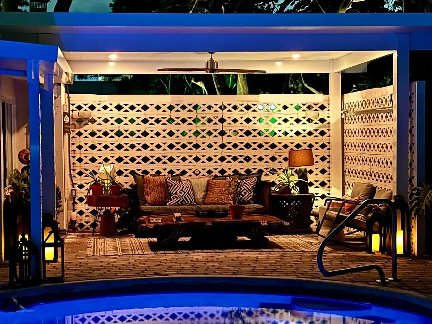 Romantic evening patio at Casa Citron featuring purple lighting and a heated pool