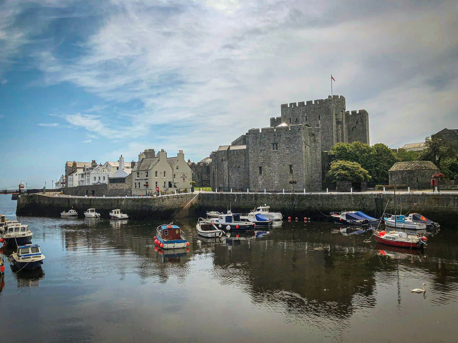 Castle Rushen above Castletown harbour, small boats at their moorings