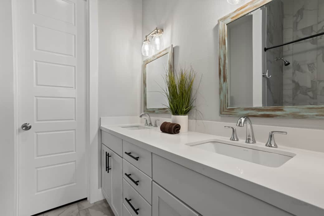 Spa-inspired bathrooms with marble tile & sleek fixtures.