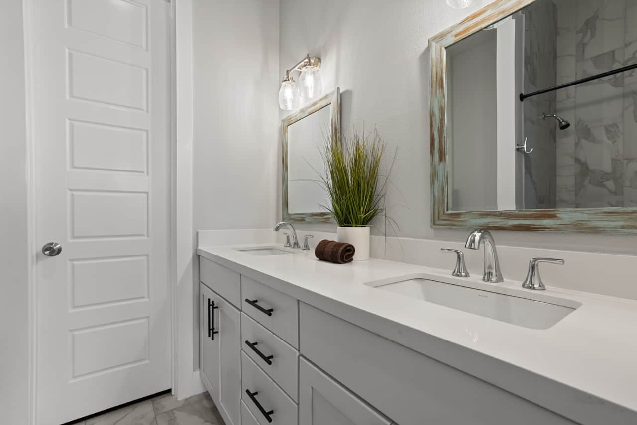 Spa-inspired bathrooms with marble tile & sleek fixtures.