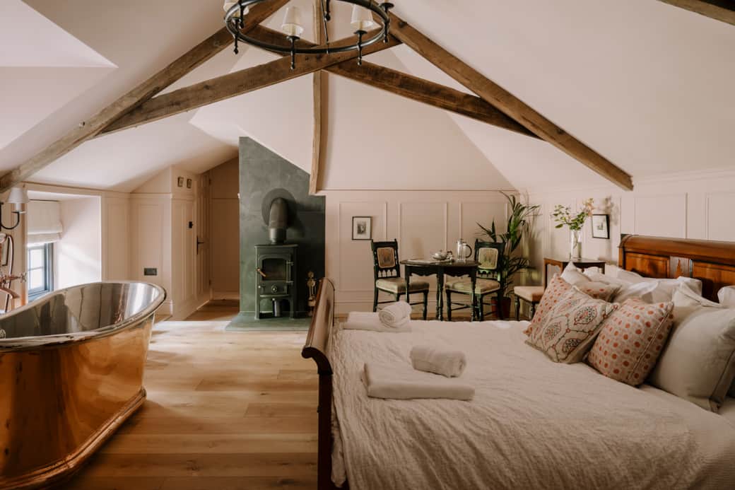 The Master Suite with Woodburner, Copper Bath & vintage Harrods sleigh bed.  Photo Credit: A Heycock