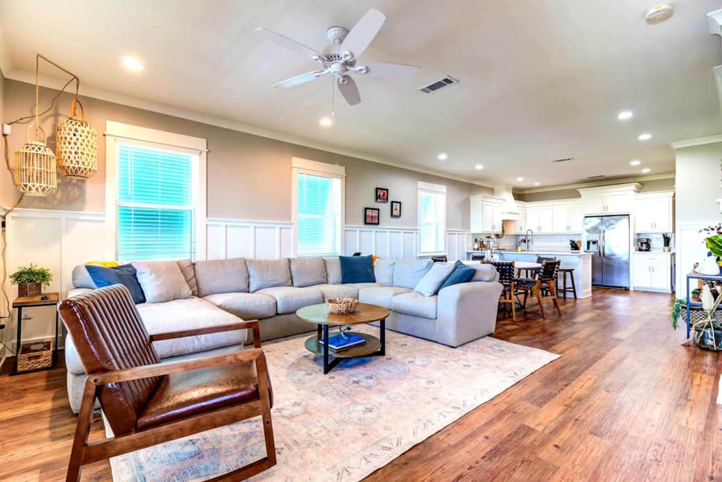 Bright coastal living room with comfy seating and bay views. Bright coastal living room with comfy seating and bay views.