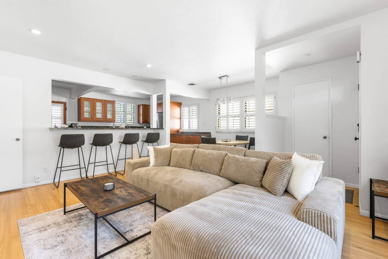 Open concept perfection! This inviting area showcases the large, plush sectional sofa and the seamless flow into the stylish kitchen with bar seating.
