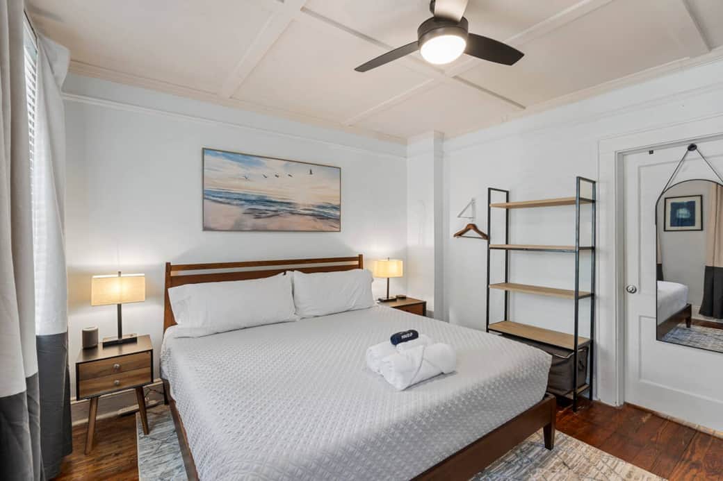 Bedroom #1 with the adjoining to bedroom #2 door closed and hanging full length mirror.  