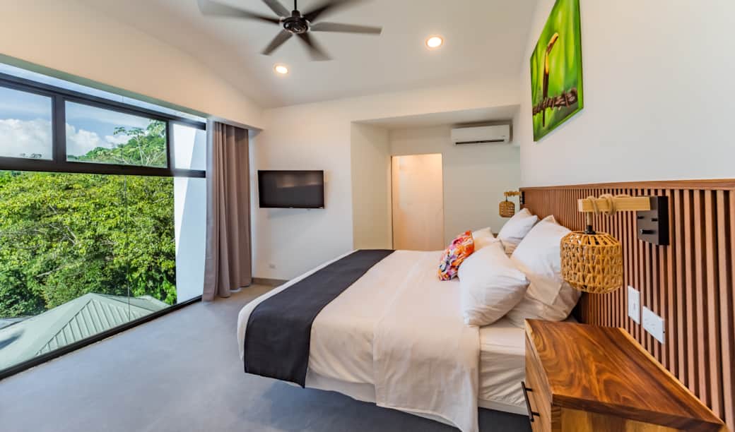 Comfortable king bedroom with modern design and peaceful jungle surroundings Comfortable king bedroom with modern design and peaceful jungle surroundings