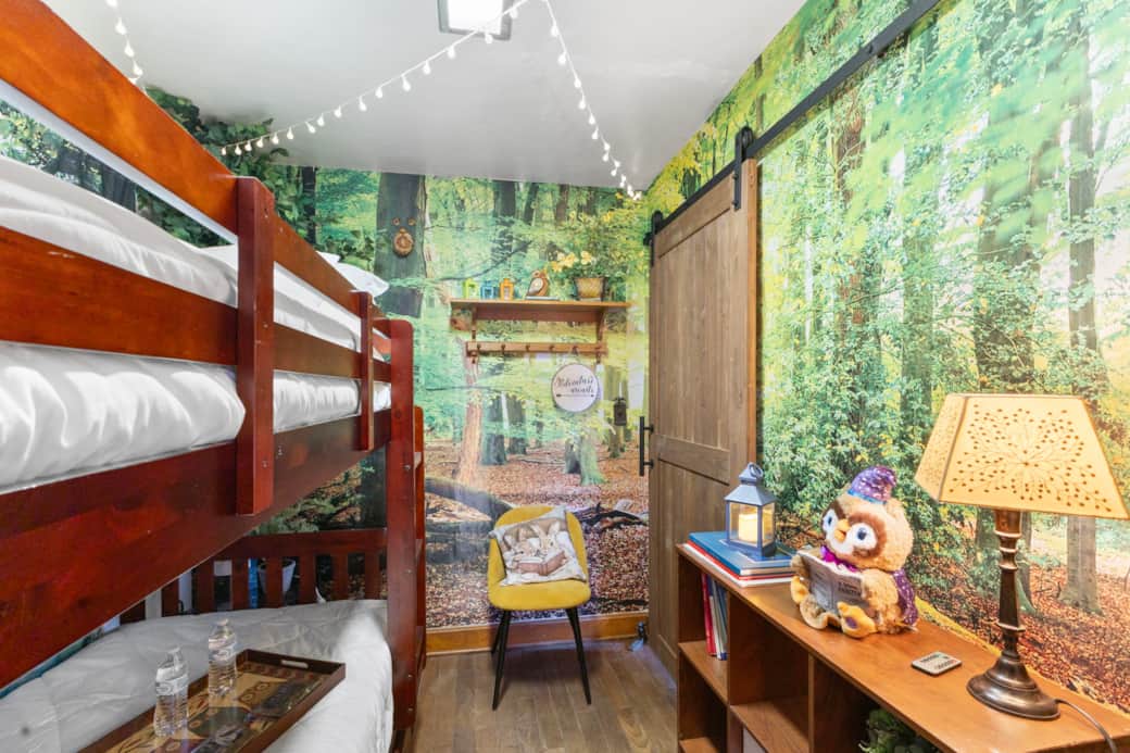 Forest themed bunk room with speciality lighting, toys and books.