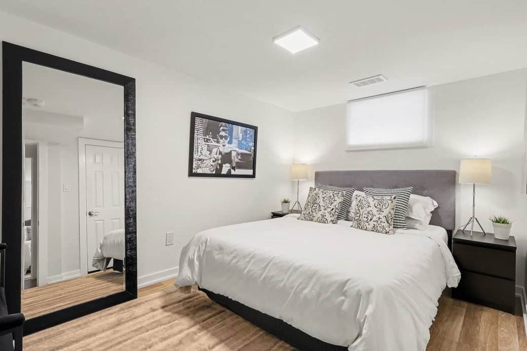 Drift off to sleep in a plush queen-sized bed with high-quality linens in this minimalist, peaceful bedroom retreat in Ottawa.