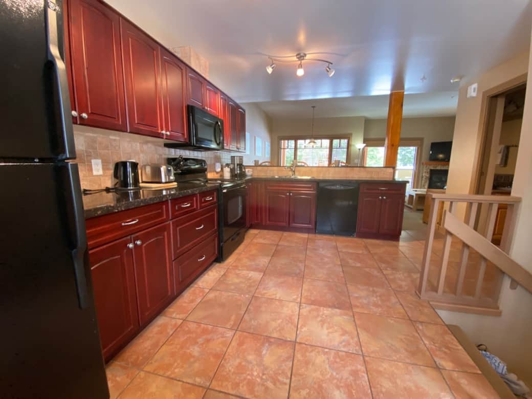 Large kitchen with expansive granite countertops and breakfast bar for 4 people.
