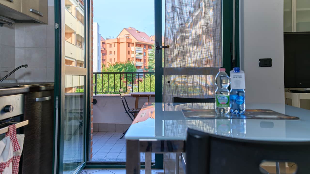 Kitchenette with oven and French window onto the balcony