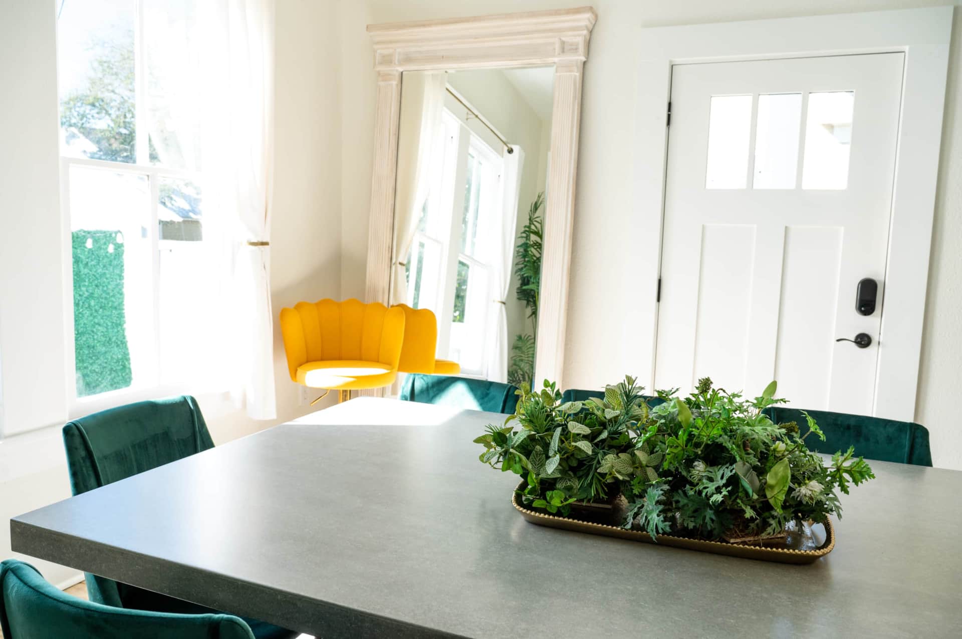 Modern dining room with seven-foot mirror.