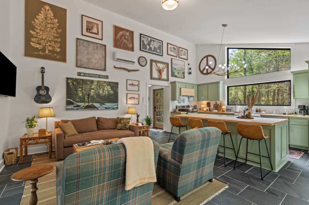 A layered mix of interesting, one-of-a-kind art and objects brings this gallery wall to life—each piece thoughtfully collected and inspired by the hosts’ love of thrifting, with subtle nods to nature, music, and the surrounding landscape.