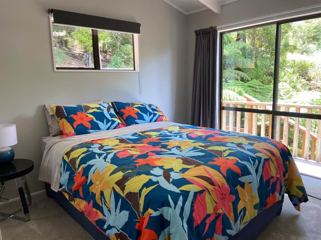 Master queen bedroom with deck access and bush views
