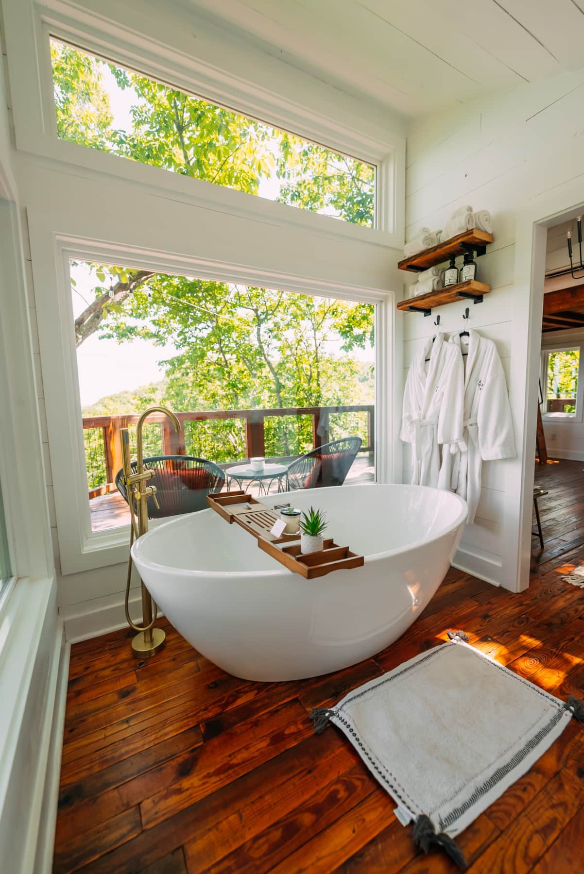 From the oversized soaking tub, you’re surrounded by quiet forest views to fully unwind.