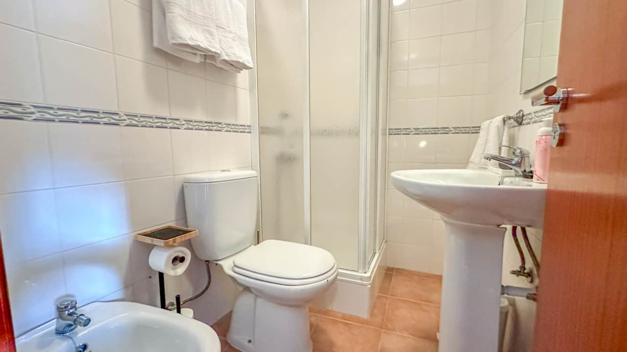 The attached bathroom has a shower, bidet, and vanity.