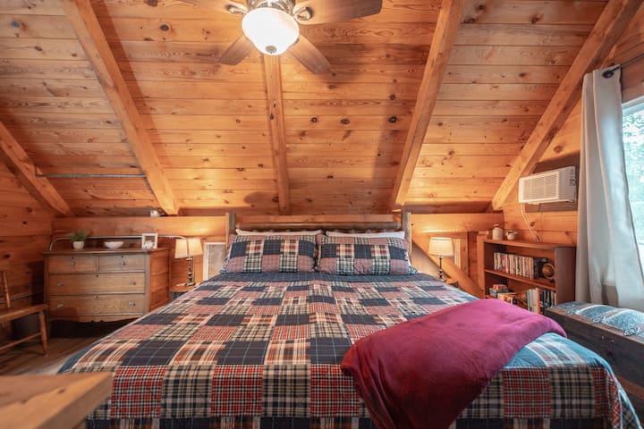 Nestled in nature: Experience ultimate comfort in our cabin's secluded king-size bedroom.