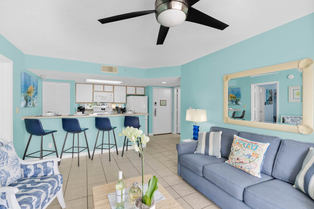 Coastal living room with breakfast bar seating and tropical Key West colors.