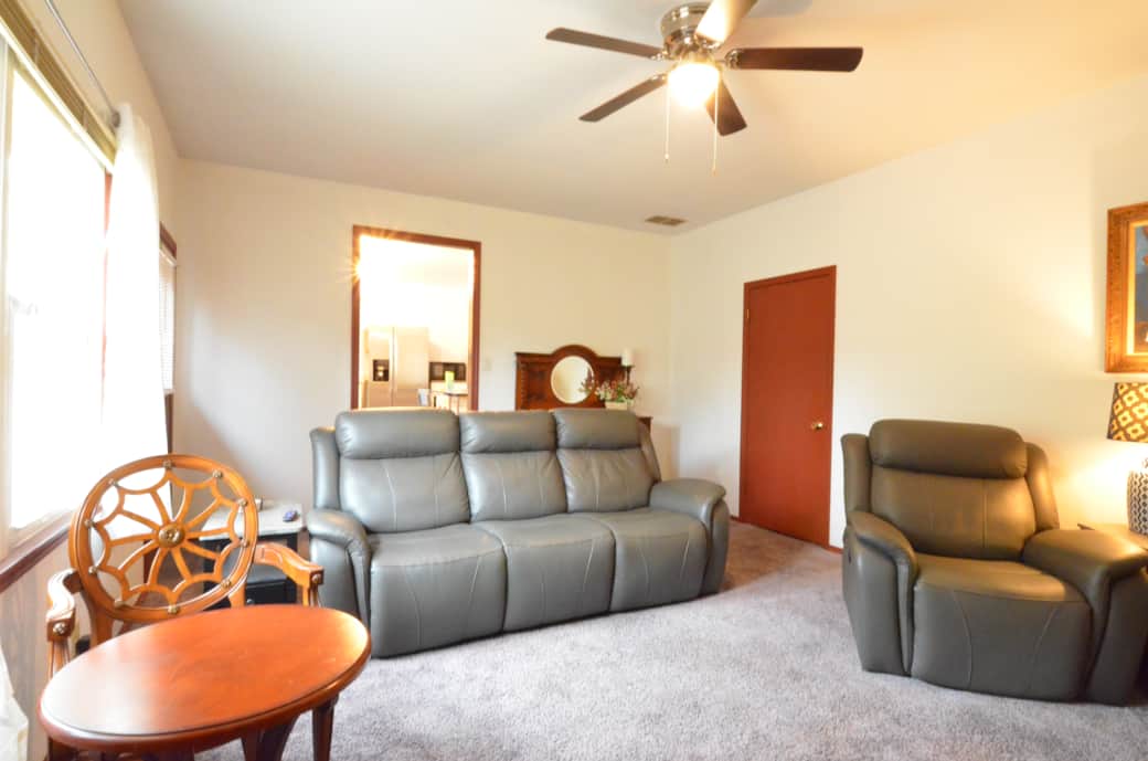 Family Room with a large Roku TV, a work area with a monitor and power, plenty  seating and games.