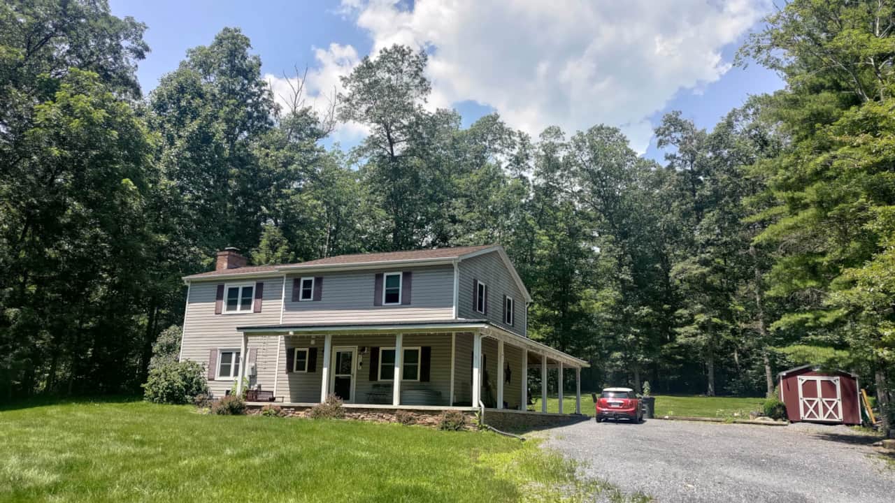 Front view w/ Porch, Parking, & Bike Shed