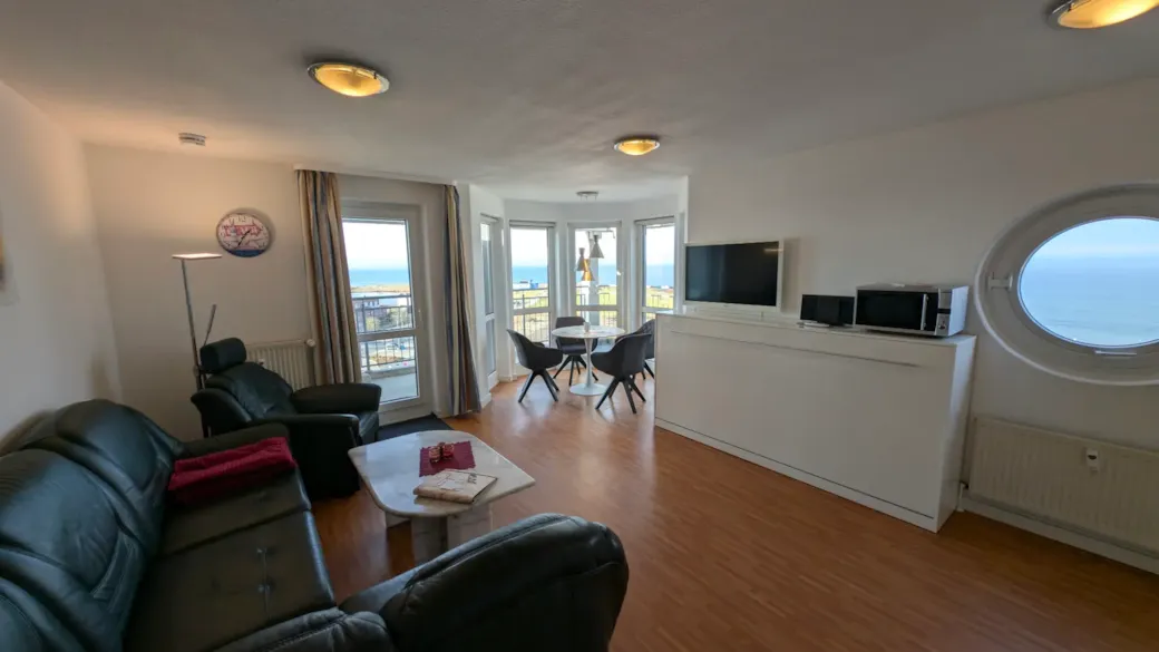 Living room with dining area and large windows facing the sea - Living room