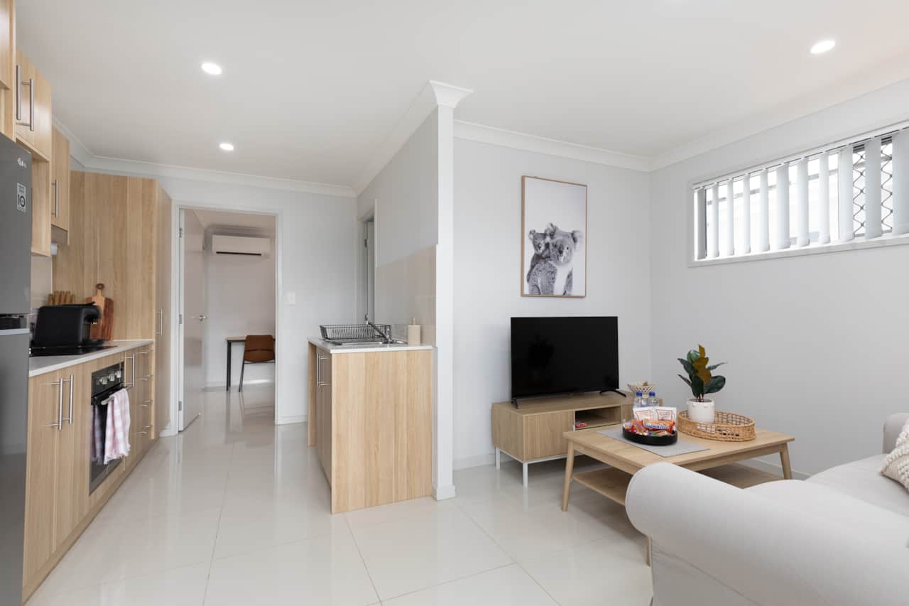 Living Area: Bright living space with comfortable seating and TV 