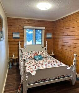 This Bedroom includes a comfortable; bed, pillows, lovely linens and luggage racks.