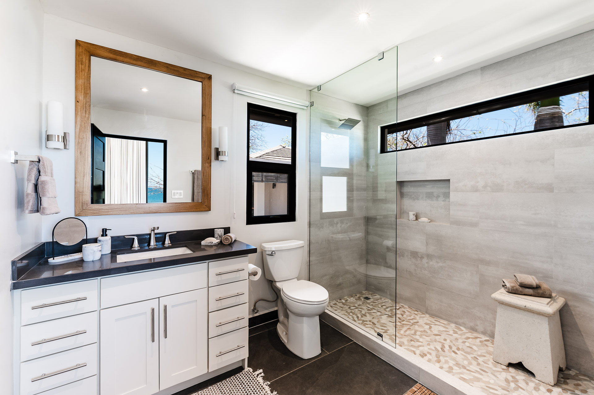 Indoor shower and single sink vanity.