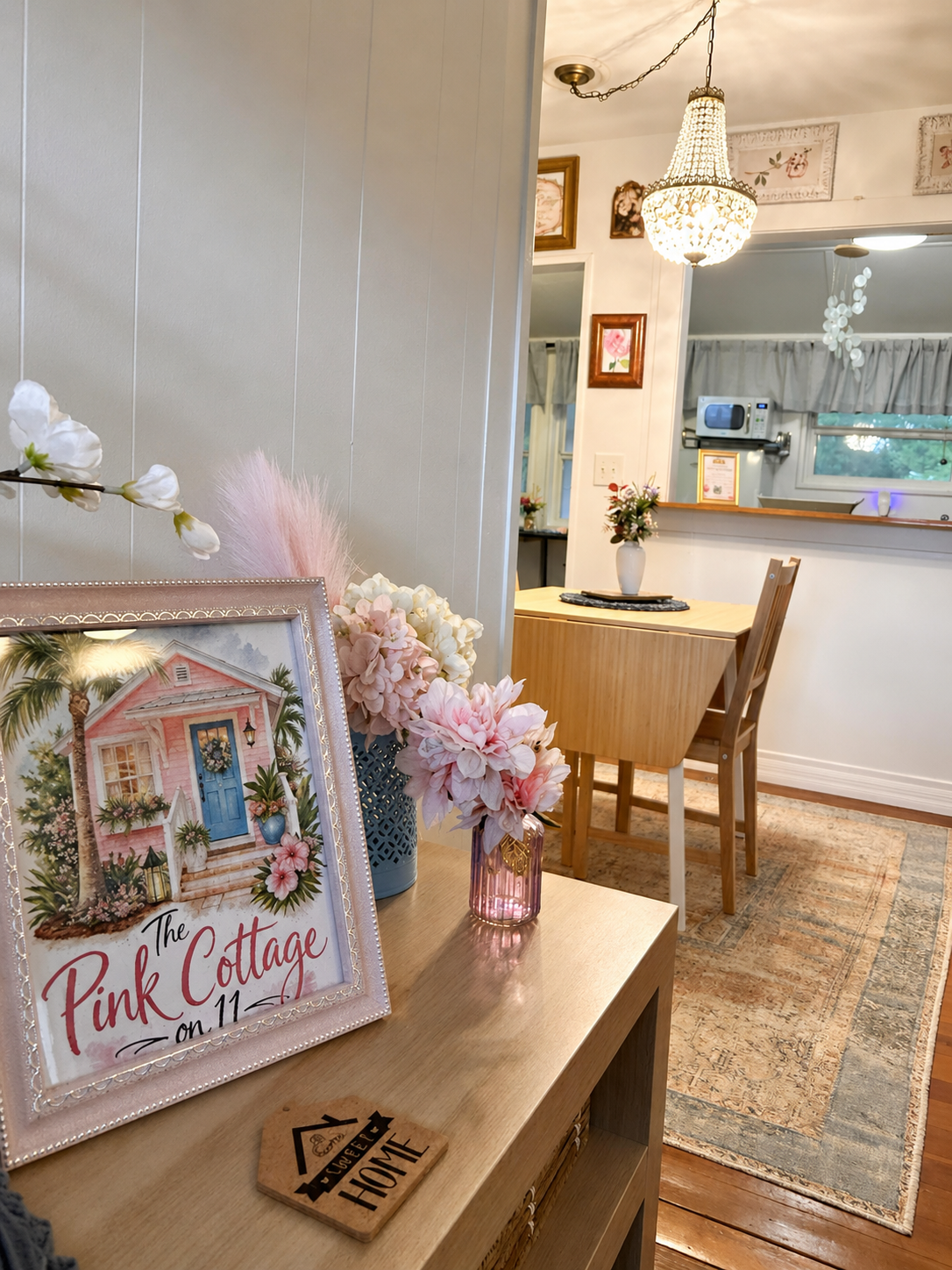 Charming dining area with stylish chandelier and open connection to the living room.