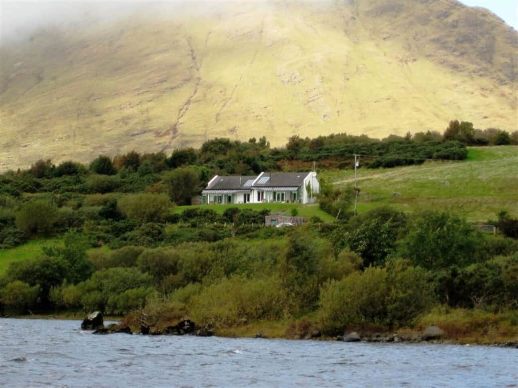 Charming lakefront cottage surrounded by rolling green hills and mountain air.