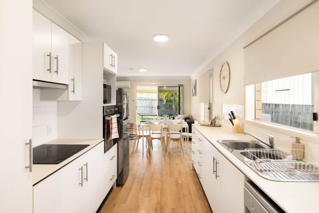 Kitchen: Sleek kitchen with ample storage, modern appliances
