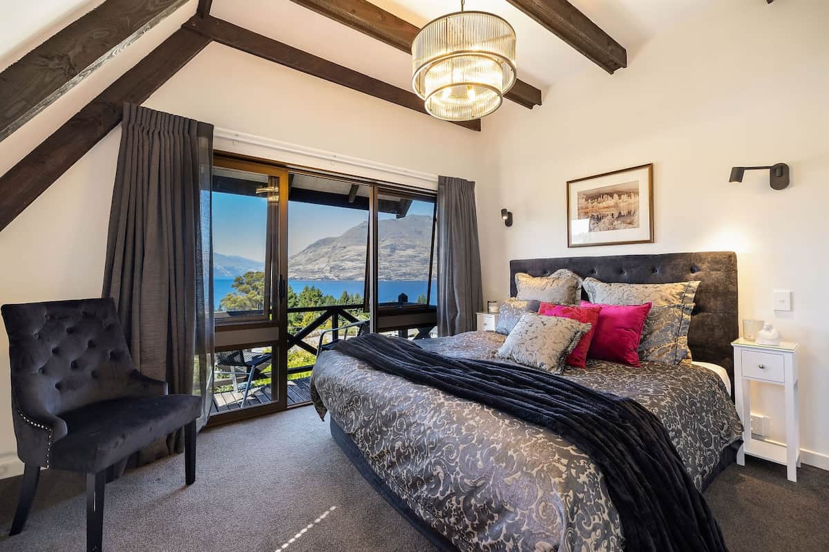 Bedroom with Lake Wakatipu views at Walk to Town 39B Alpine Chalet Queenstown