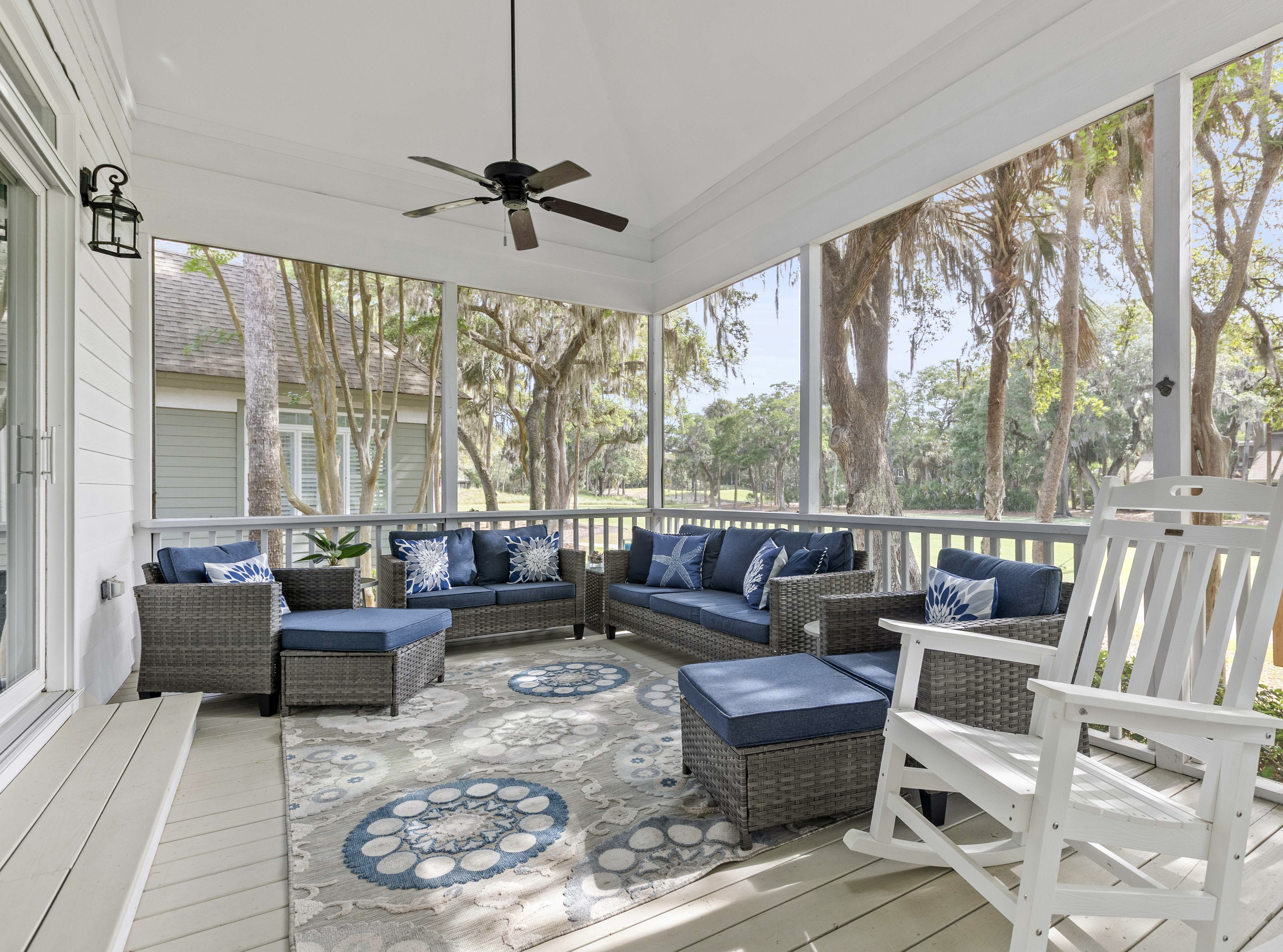 Screened porch seats all ten, with a ceiling fan overhead