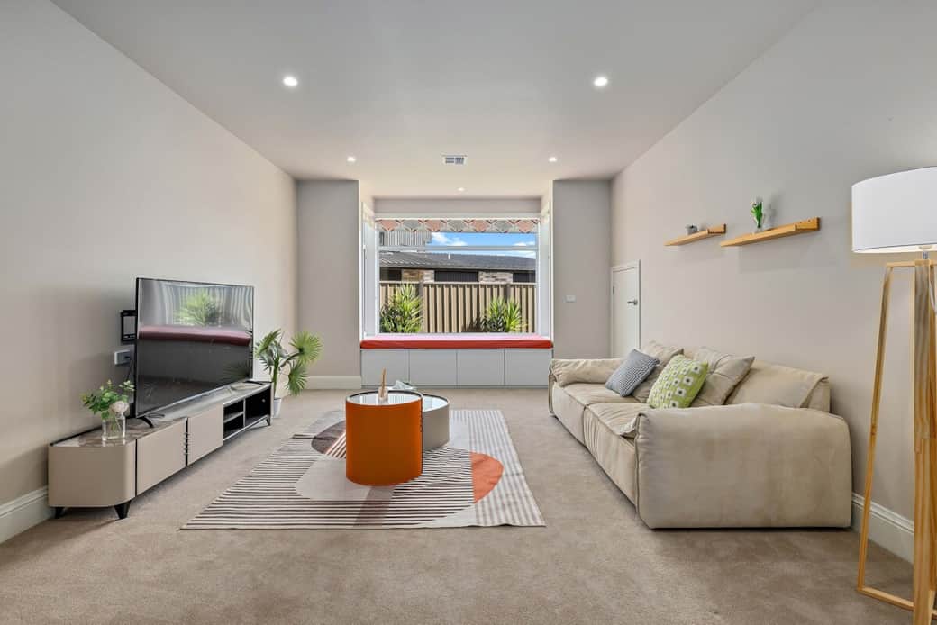 Step into our inviting living room, where comfort meets contemporary design. The plush sofa and vibrant orange accents create a warm atmosphere. Enjoy watching your favorite shows on the TV or relax by the window, soaking in the views of the balcony.