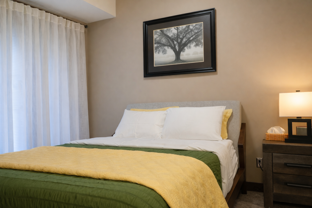 Primary bedroom with patio access, walkthrough closet, ensuite, and smart TV.