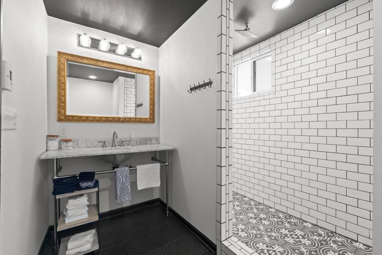 Clean and modern bathroom with a sleek vanity and walk-in shower featuring classic subway tile.