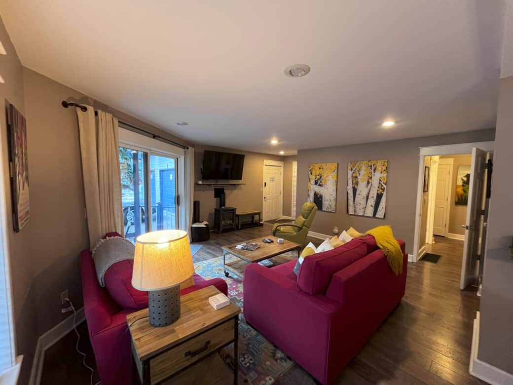 Living room area features plenty of seating, flat screen TV and gas fireplace