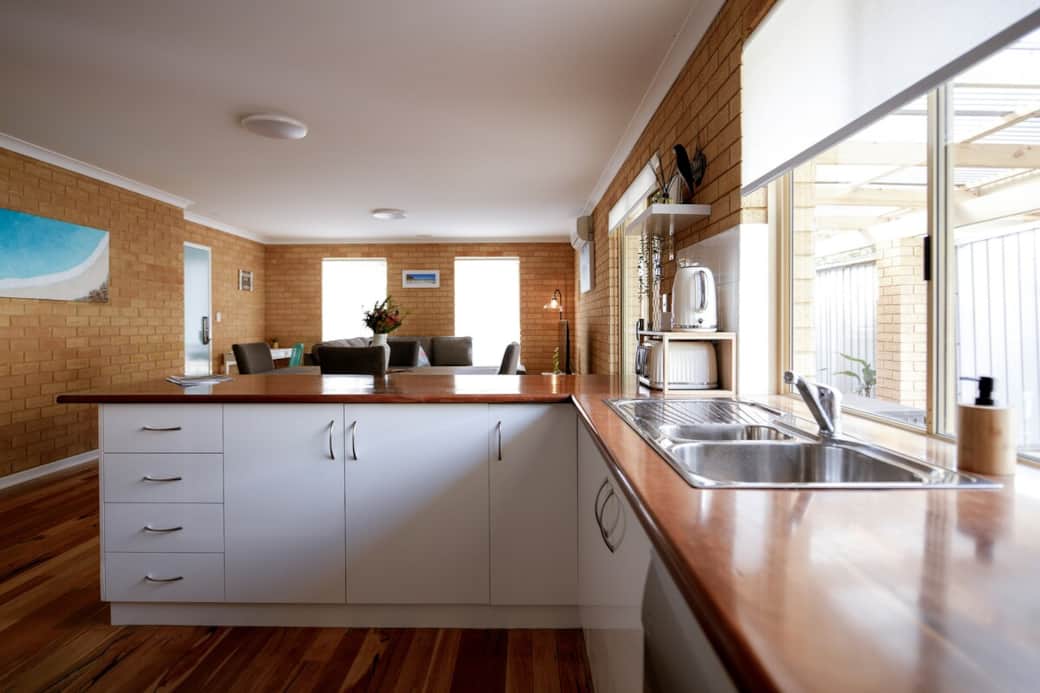 Fully equipped kitchen with a dishwasher, microwave, rice cooker, toaster & kettle. Starter supplies include long-life milk, individually packaged sugar, tea, and instant coffee.