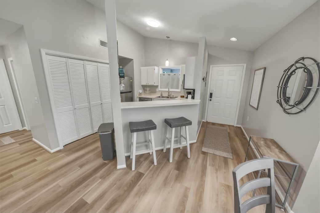 Bar seating between the dining and kitchen provides casual seating for guests' enjoyment