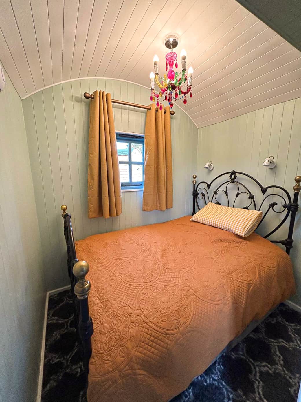 Cosy double bedroom with vintage iron bed and charming rustic décor.