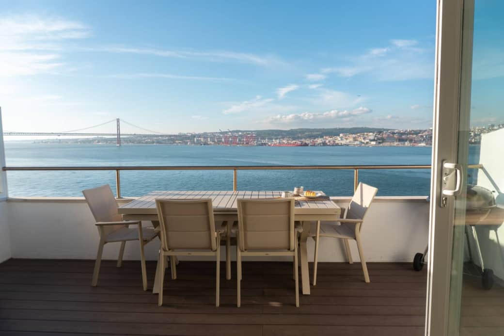The spacious balcony, with dining for 6, a BBQ, and panoramic views of the bridge and city.