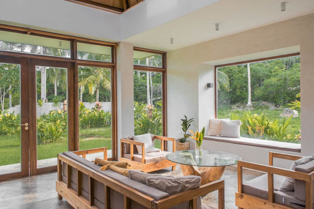 Lounge in the window nook or relax on the sofas while takin gin the tropical surrounds