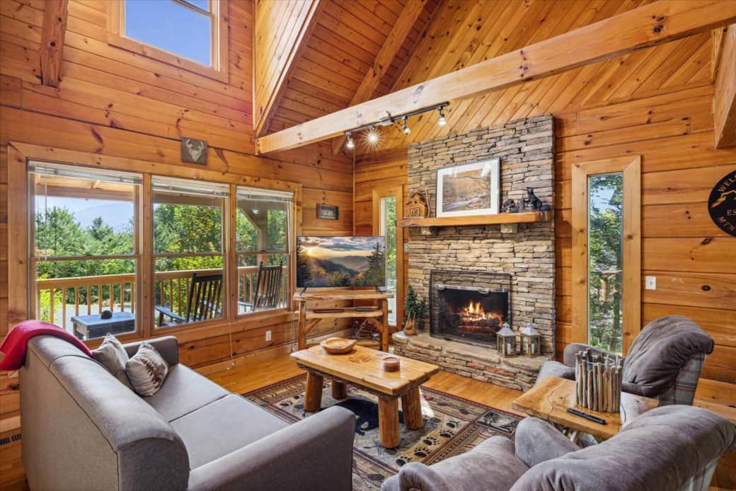 Living room with a view and a cozy fireplace and smart tv